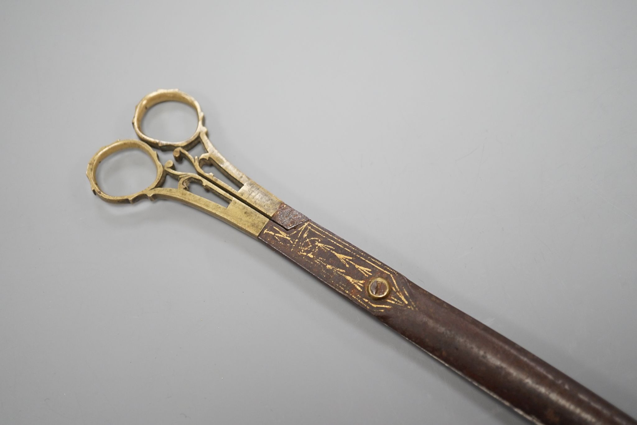 A pair of Ottoman gold damascened iron scissors, 23 cms long.